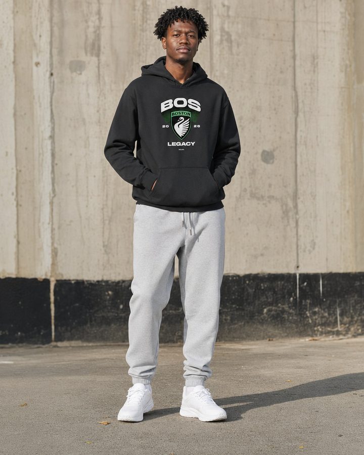 BOS hoodie, full body, against a concrete wall