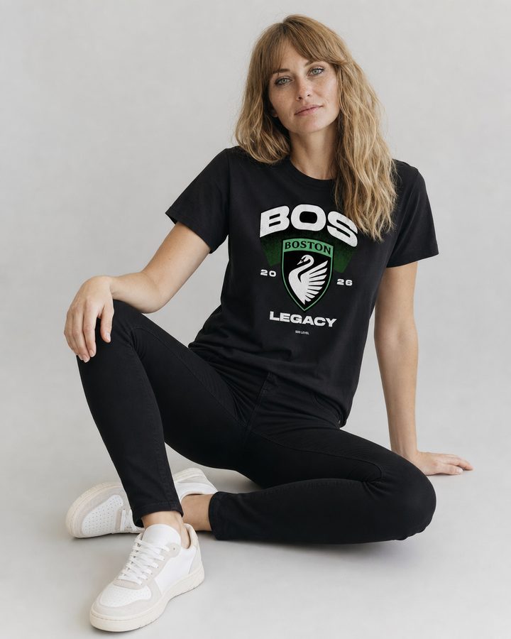 BOS t-shirt, seated, on a white studio backdrop